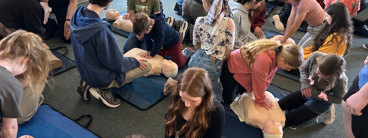 Youth from Homeschool Fine Arts learning hands-only CPR